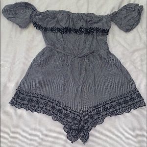Cute romper with checkered print and lace detailing. Also off the shoulder.